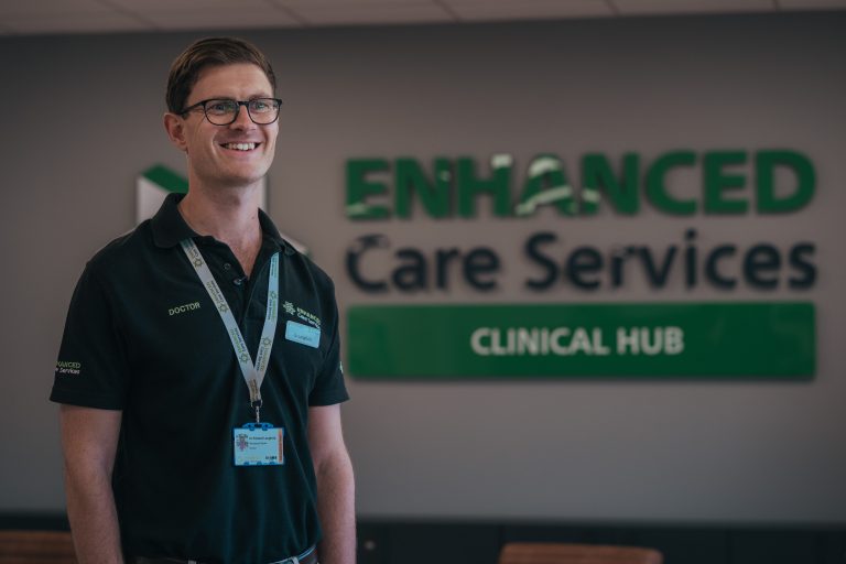Person in front of enhanced care sign